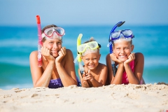 three happy children on beach...